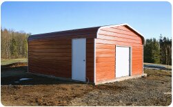 Red metal barn or agricultural storage building with white roll-up door and side entry door