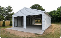 White metal garage with wide open front entrance and concrete floor for vehicle parking and storage