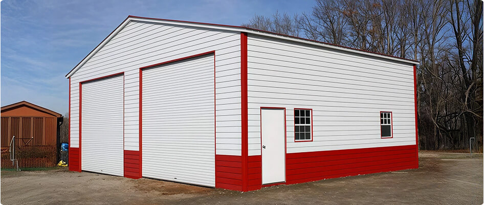 A red-and-white large metal garage with lap siding