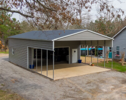 Gray metal garage with a front porch, large sliding glass doors, walk-in entry, and an attached covered outdoor area.