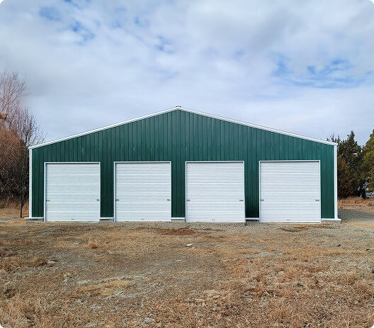 Green garage with four white doors